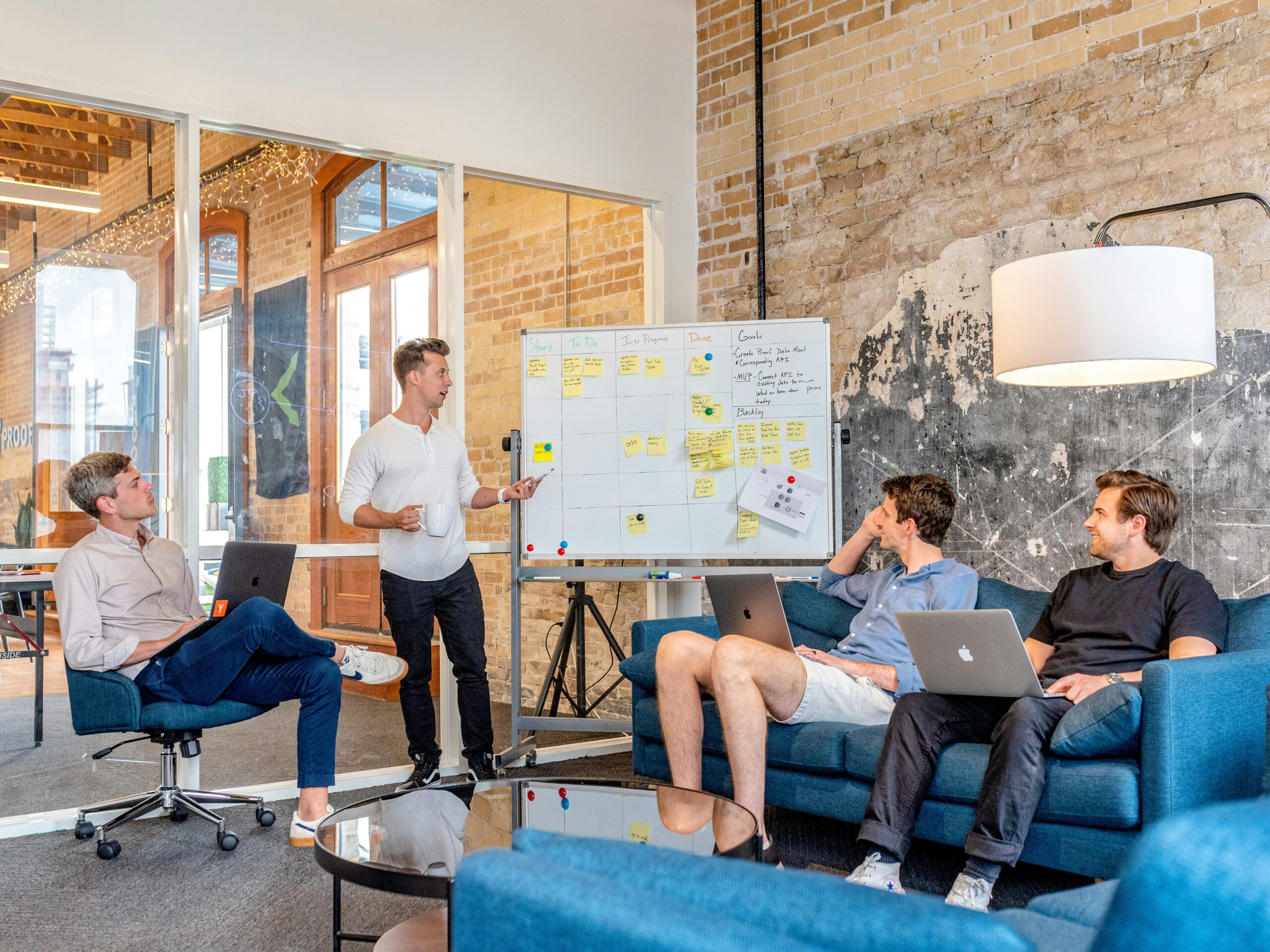 A group of people discussing the contents of a whiteboard.